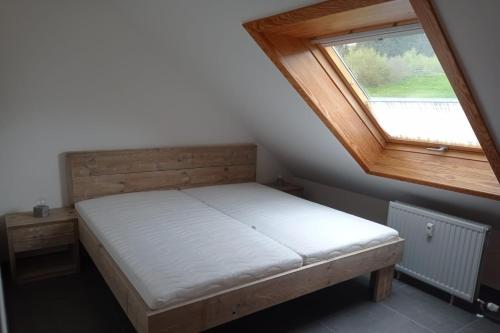 a small bed in a room with a window at Ferienwohnung Pistenblick in Winterberg in Winterberg