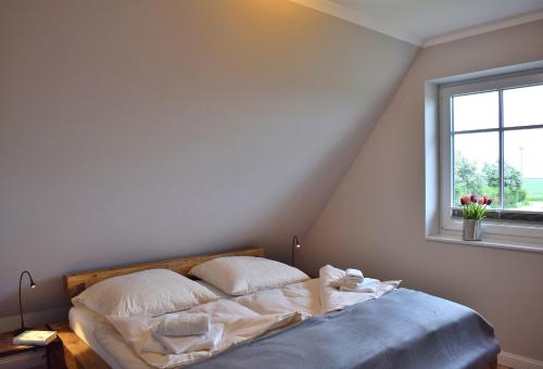 Ein Bett oder Betten in einem Zimmer der Unterkunft Reethaus 3B