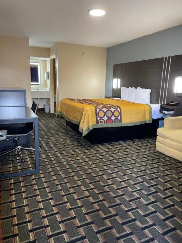 a hotel room with a bed and a desk at New Hampshire Inn West Memphis in West Memphis