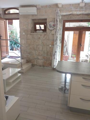 a kitchen with a counter and a stone wall at Apartment Vita in Korčula