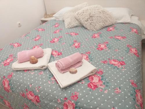 a bed with two towels and two trays on it at Apartment Vita in Korčula