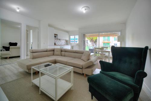 - un salon avec un canapé, une chaise et une table dans l'établissement IMMOGROOM - Terrace - Near shops - Parking - Wifi - AC livingroom, à Cannes