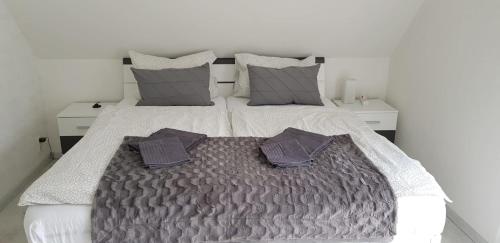 1 cama blanca grande con 2 almohadas en Ferienhaus Rosenbach, en Bischdorf