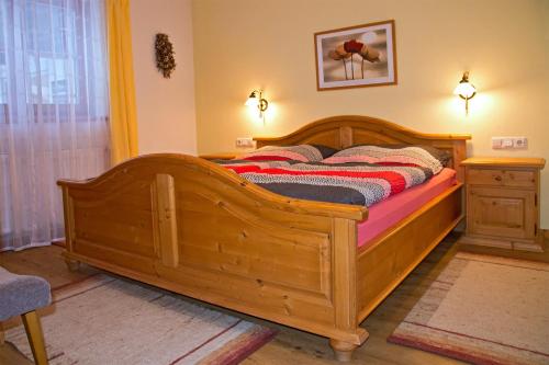 a bedroom with a wooden bed in a room at Haus Savoy - Appartement 1 in Kitzbühel