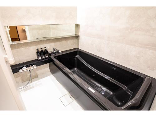 a bathroom with a black sink and a mirror at HOTEL KARUIZAWA CROSS - Vacation STAY 56435v in Karuizawa