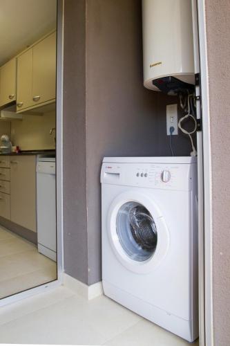 a white washer and dryer in a kitchen at Rentalmar Paradise Families Only con parking in Salou