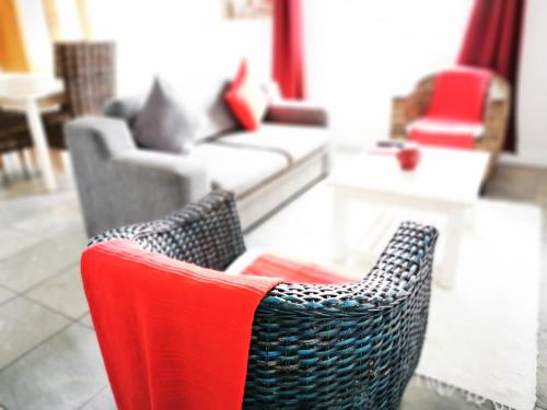 a living room with two chairs and a couch at Bellamente Sirene in Gansbaai