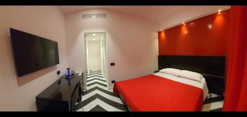 a bedroom with a red bed and a flat screen tv at The White Lodge in Sorrento