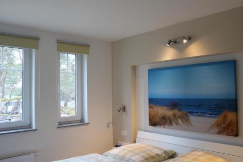 a bedroom with a large picture of the ocean on the wall at Strandvilla Sophie App 2 in Dierhagen