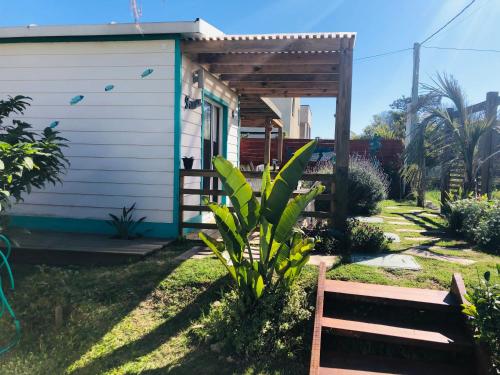 a small house with a bench in front of it at Posada Agua Marina in La Paloma