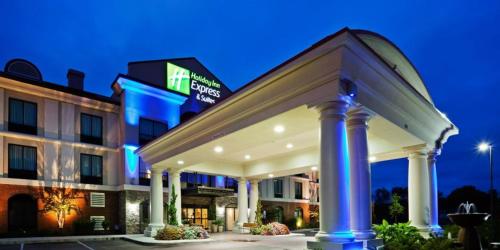 a hotel building with a lit up sign on it at Holiday Inn Express Hotel & Suites Mount Juliet - Nashville Area, an IHG Hotel in Mount Juliet