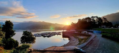 a view of a river with the sunset in the background at D'Oliva Gerês - River Side Houses in Geres