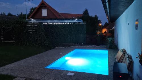 a swimming pool in a backyard at night at Chaloupka Rozkoš in Nové Město nad Metují