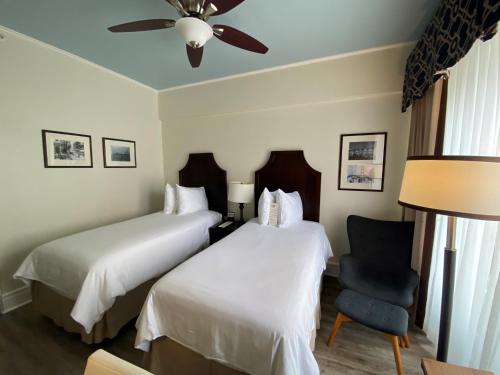 a hotel room with two beds and a chair at Chancellor Hotel on Union Square in San Francisco