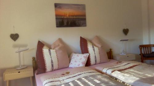 a bedroom with a bed with pillows on it at Ferienwohnung Klein am Natursteig Sieg in Bitzen