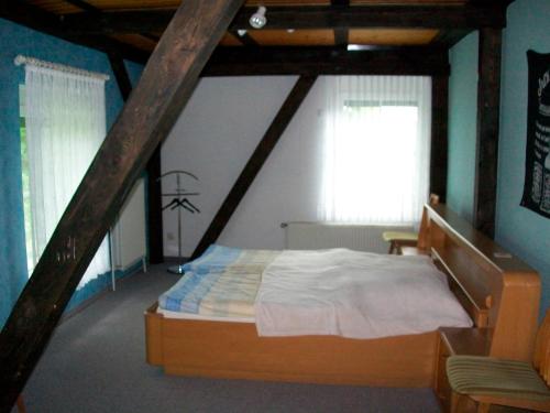 a bedroom with a large bed in a attic at Doppelzimmer 1 Gotthard in Hanerau-Hademarschen