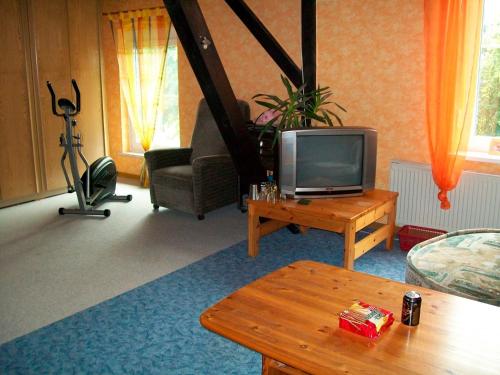a living room with a television and a coffee table at Doppelzimmer 1 Gotthard in Hanerau-Hademarschen