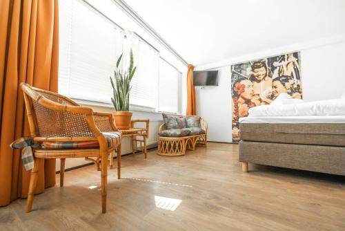 a bedroom with a bed and a chair at Pink Flamingo Boutique Hostel in The Hague