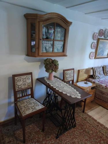 a dining room with a table and two chairs at Cafe Nostalgie dvoulůžkový romantický pokoj in Krásná Lípa