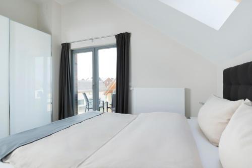 Un ou plusieurs lits dans un hébergement de l'établissement Ostsee - Appartement Nr 55 "Marina Loft" im Strand Resort