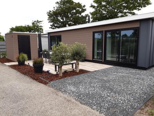 a small house with a bench in front of it at Beachhouse Renesse 2645 in Renesse