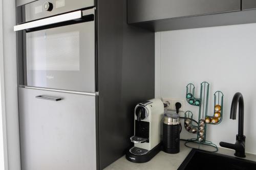 a kitchen with a white refrigerator and some utensils at Beachhouse Renesse 2645 in Renesse