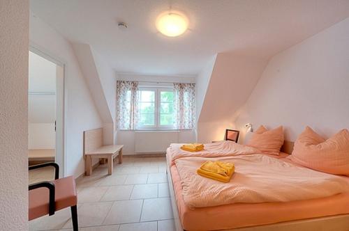 ツィングストにあるStrandglück FH 2のベッドルーム1室(ベッド1台、椅子、窓付)