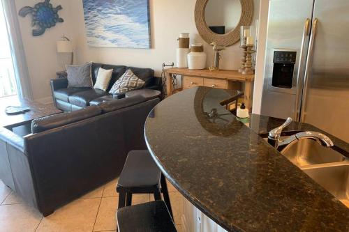 a kitchen with a counter top and a living room at Luxury and Spacious Waterside Getaway in Clearwater Beach