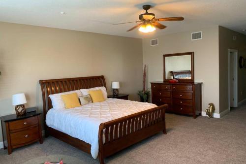 a bedroom with a large bed and a ceiling fan at Luxury and Spacious Waterside Getaway in Clearwater Beach