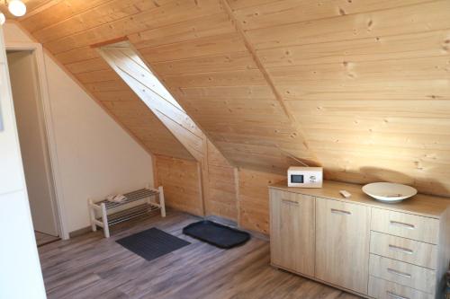 a attic room with a wooden ceiling with a skylight at Ferienwohnung Seeblick Nr 5, 2 Zi-Bärental, Feldberg in Feldberg