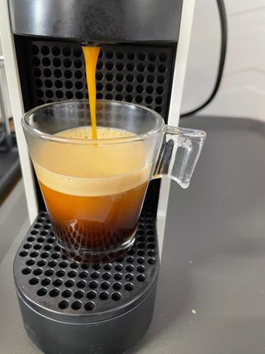 a drink is being poured into a coffee maker at Casa Paixanita - jacuzzi & terrace downtown Olhao in Olhão