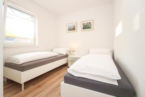 Postel nebo postele na pokoji v ubytování Siel&Sonne in Greetsiel