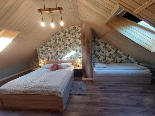 a bedroom with two beds in a attic at Willa HAFEN in Jastarnia