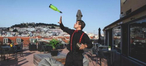 a man is holding up a knife on a roof at The ART INN Lisbon in Lisbon