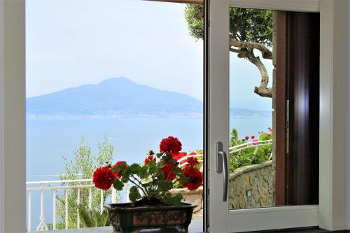 a door to a balcony with a view of the ocean at MiraSorrento in Sorrento