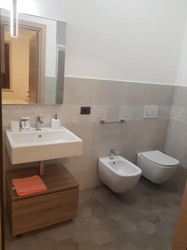 a bathroom with a sink and a toilet at B&B al civico16 in Guspini