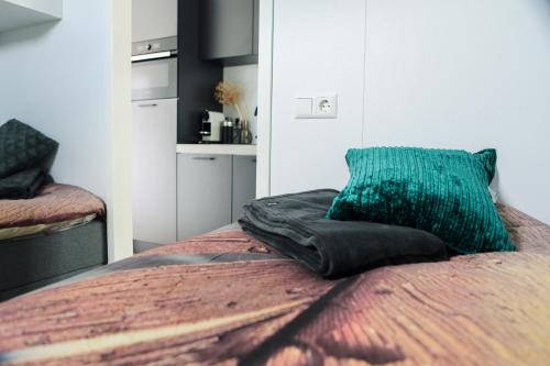 a bed with a green pillow on top of it at Beachhouse Renesse 2645 in Renesse