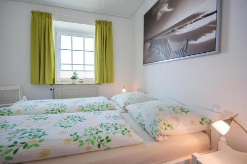 1 Schlafzimmer mit 2 Einzelbetten und einem Fenster in der Unterkunft Knusthof Lafrenz - Küstenblick in Fehmarn
