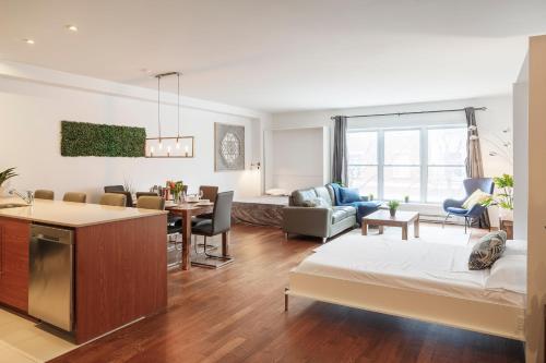a living room with a kitchen and a living room with a couch at Suite Mont-Royal by MTLVacationRentals in Montréal