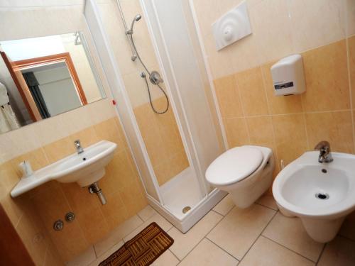 a bathroom with a sink and a toilet and a shower at Hotel Il Melograno in Mattinata