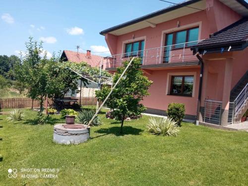 a house with a tree in the yard at Guest House Ahmo Halilcevic in Dubrave Gornje