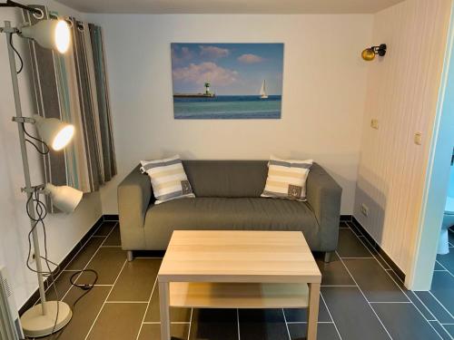 a living room with a couch and a coffee table at Segellast 5 in Lübeck