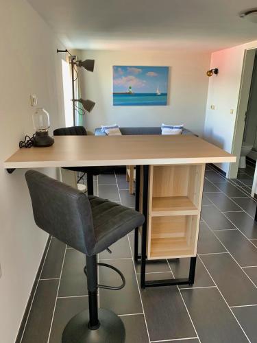 an office with a desk and a chair and a table at Segellast 5 in Lübeck