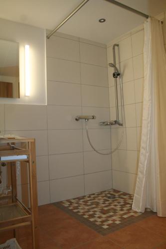 a shower with a shower curtain in a bathroom at Wallberg in Bad Wiessee