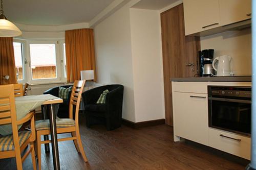 a kitchen and living room with a table and chairs at Wallberg in Bad Wiessee