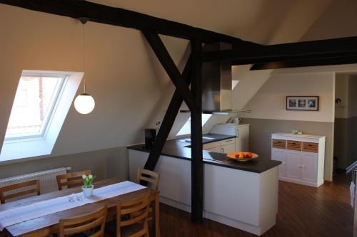 a kitchen and dining room with a table and a stove at Bauernhof Höpner "Im Backhaus" in Vadersdorf