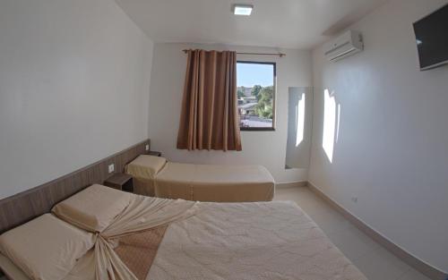 Cama ou camas em um quarto em Hotel Natureza Foz