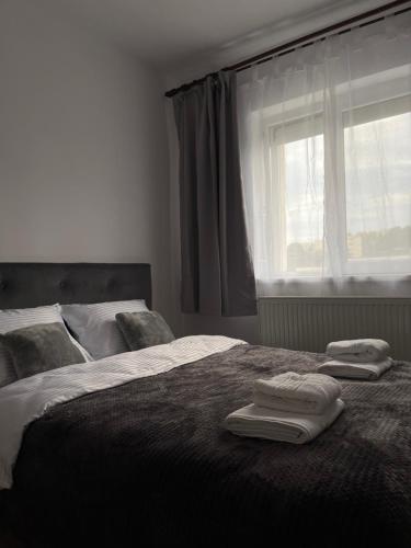 a bedroom with two beds with towels on top of it at Cozy Studio 1 Bedroom nearby Value Center Mall in Zalău