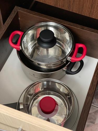 two pots and pans sitting on top of a stove at Cozy Studio 1 Bedroom nearby Value Center Mall in Zalău