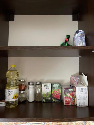 a shelf with some food and a bottle on it at Cozy Studio 1 Bedroom nearby Value Center Mall in Zalău